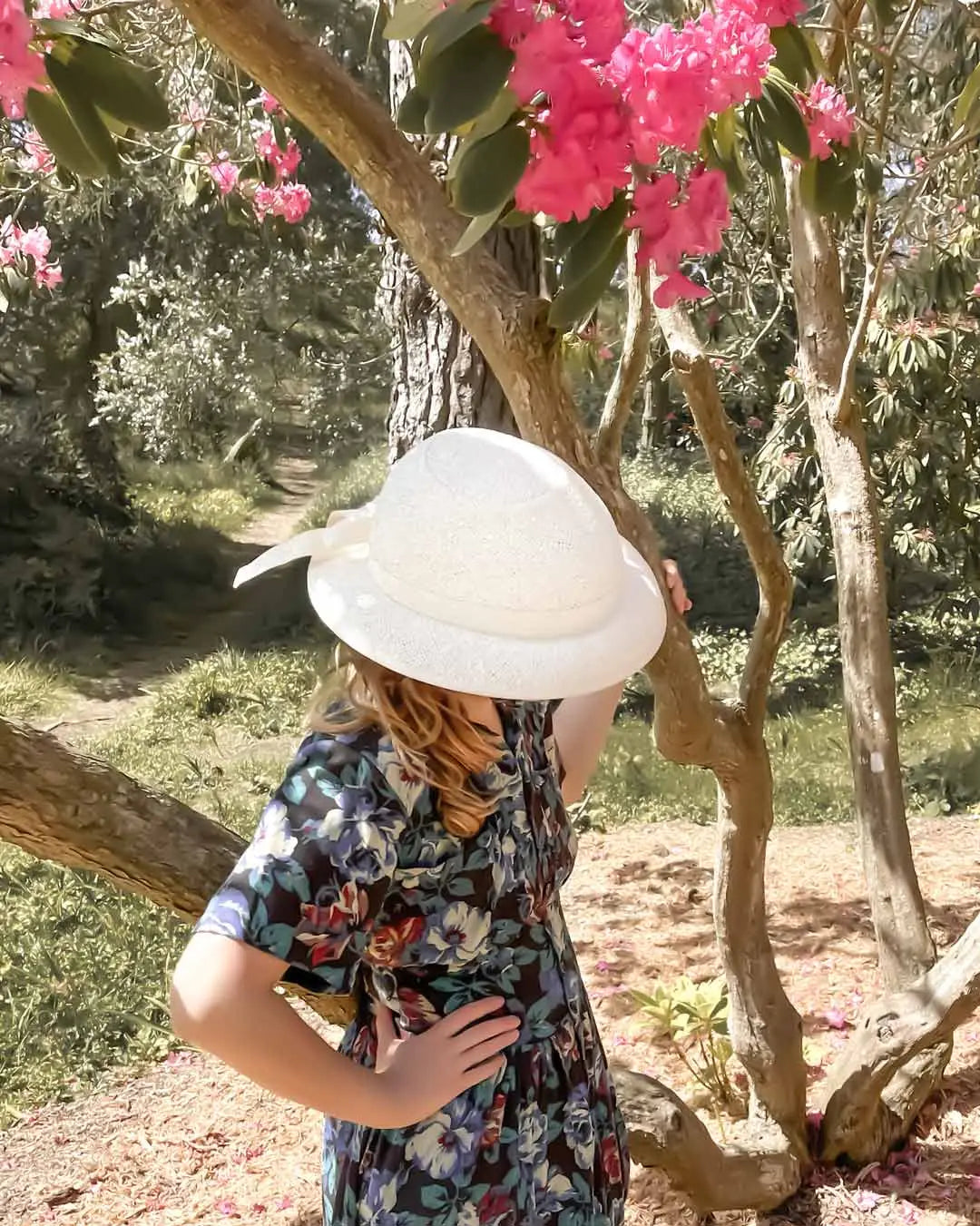 Ivory straw hat helmet cover with white woven straw and feather detail