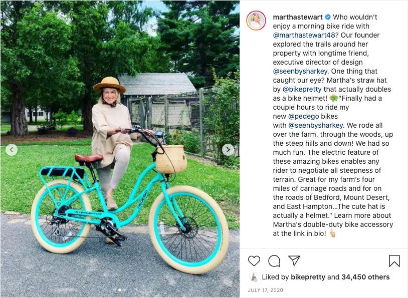 Teal electric bike with cream tires and Straw Hat Bike Helmet on handlebars